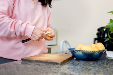 Cutting potatoes at home to cook. 