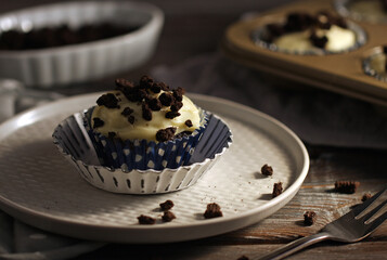 chocolate muffin with vanilla cream on the top