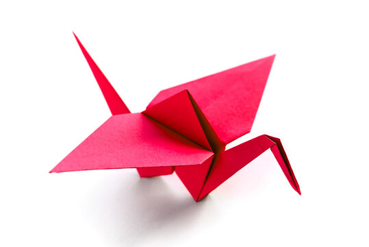 Red paper crane origami isolated on a white background