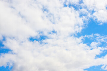 White cumulus clouds in a blue sky