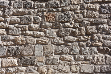 Three-dimensional texture of the old stone wall.