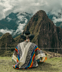 Tourist photography in Machu Picchu. Traveler with poncho and Inca hat. Wonder of the World. Colors