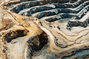 Industrial terraces in a mining quarry. Aerial view of open pit mining. Excavation of the Dolomite Mine. Extractive industry.