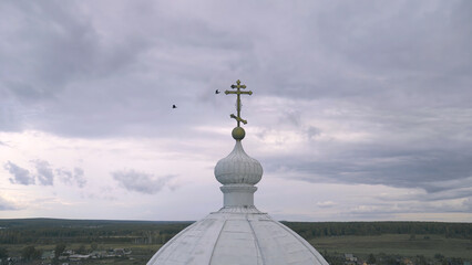 Man and woman look at dome of Church. Stock footage. Man and believing woman stand on balcony of Church and look at dome with cross