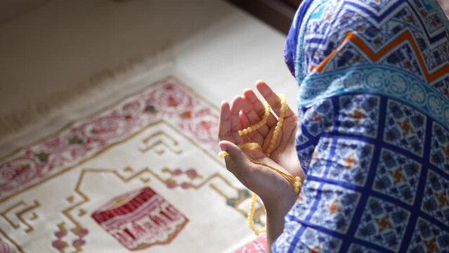  rear view of muslim women hand praying at ramadan 