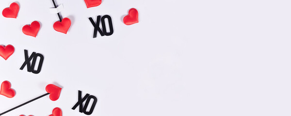 Banner with Valentne's day cupid's love arrows and text XO on white background with copy space