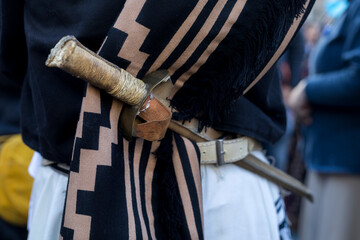 Rear view in detail of the traditional belt and knife (facon) of an Argentine gaucho. Close-up,...