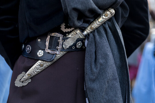 Rear view in detail of the traditional belt and knife (facon) of an Argentine gaucho. Close-up, unrecognizable person. Concept Argentine Culture and Traditions