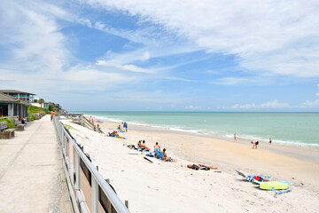 Tourists relaxing at a sandy beach on a beautiful, calm day in Vero Beach, Florida