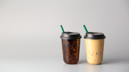 Iced americano coffee and coffee milk on grey background, coffee package for takeaway, Cold beverage product.