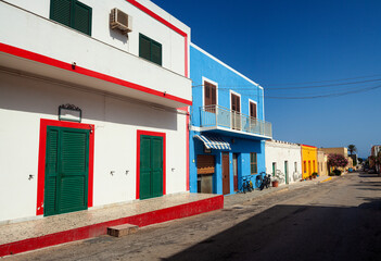 View of a typical colorful houses of Linosa, colored with white red and cyan