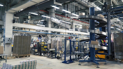 Worker distributing goods in a storehouse with forklift truck loader. Clip. Man driving a loading machine during the operation of the plant
