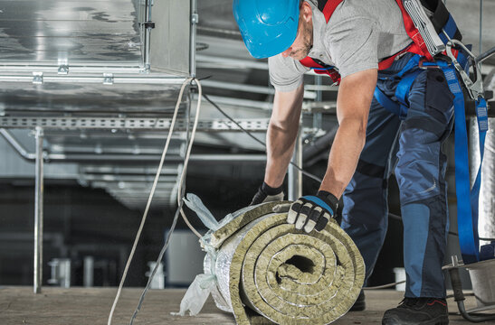 Worker with Piece of Mineral Wool Insulation