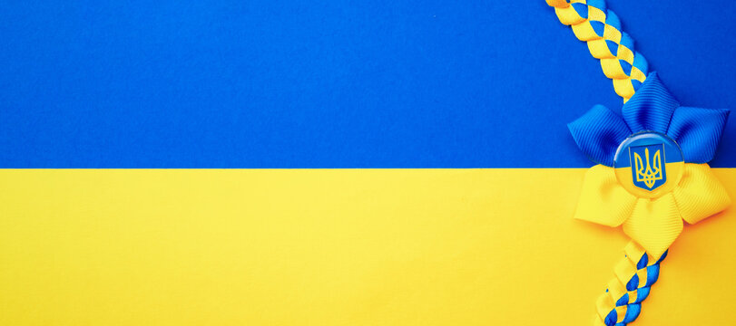 Ukrainian Flower Trident Symbol Isolated On Yellow Blue Flag. Yellow And Blue Banner Background, Flat Lay, Copy Space.