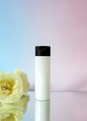 Mockup white plastic tube for moisturizer, lotion, facial cleanser or shampoo on smudged cream.