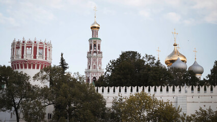 Beautiful Church buildings and towers behind wall. Action. Architectural ensemble of monastery with...