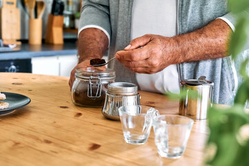 Fototapeta na wymiar Man preparing classic Italian coffee in the mocha in the kitchen, filling funnel of a moka pot with ground coffee. Coffee brake. Morning habit.