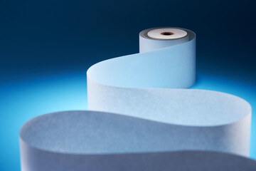 blank adding machine tape against blue background