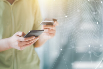 Women are holding credit card and using mobile phone. Online payment Concept.
