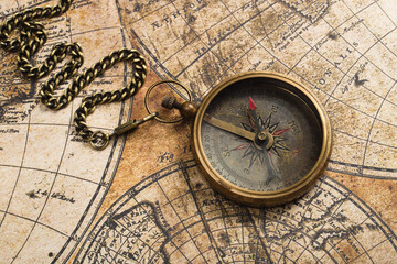 Old compass on vintage map. Adventure retro style.