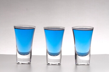 Three alcoholic multicolored alcoholic shots for advertising layout