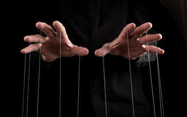 Man hands with strings on fingers. Manipulation, negative influence or addiction concept. Becoming dependent on alcohol, drugs, gambling. High quality photo - obrazy, fototapety, plakaty