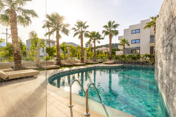 Fototapeta na wymiar Sea hotel resort with swimming pool in the morning