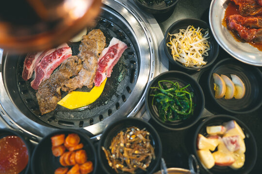 Top View Of Korea BBQ Style Restaurant With Side Dish