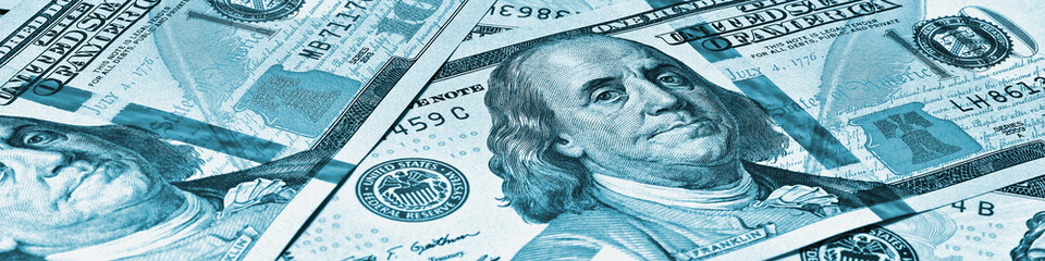 American paper money. 100 dollar and other US notes. Blue tinted banner or header. Savings economy and USA dollar. National debt and Treasury