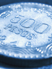 Translation: 500 Colombian pesos Republic of Colombia. Colombian coin 500 pesos. Peso of Colombia. News about economy or banking. Loan and credit. Wages and taxes. Blue tinted vertical illustration