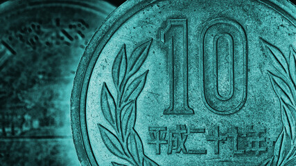 Translation: 2015. Japanese coins of 10 yen on both sides close up. Dark turquoise tinted background or wallpaper. Money, economy and banks of Japan. Backdrop on taxes and financial management. Macro