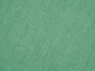 Green woven surface closeup. Linen texture. Fabric background. Textured braided natural backdrop