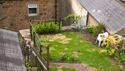 Small back garden with patchy grass
