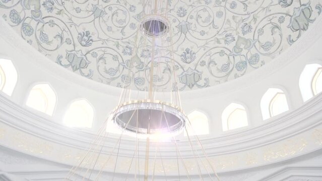 Decorative ceiling and walls with a hanging chandelier. Scene. Beautiful ornament and relief, concept of interior architecture.