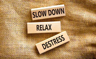 Destress symbol. Concept words Slow down Relax Destress on wooden blocks. Beautiful canvas table canvas background. Psychological business slow down Relax destress concept. Copy space.
