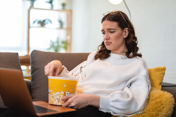 Beautiful woman watching sad movie. The woman made a sad face looking movie