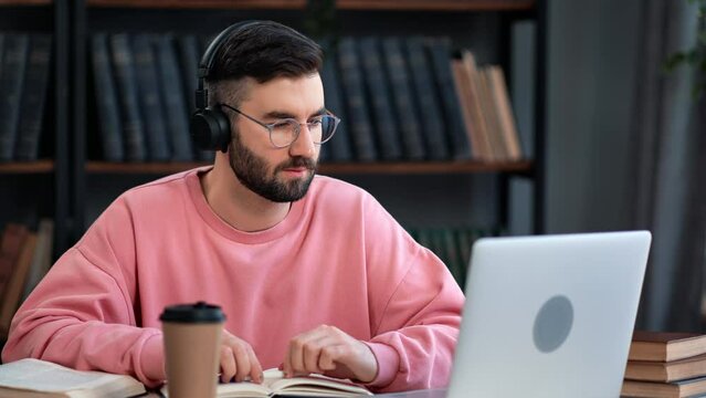 Confident male in headphones online video call distance education e learning exam consulting laptop