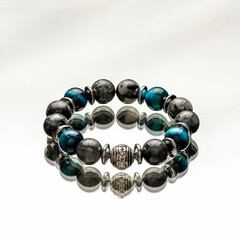 a bracelet made of stones made by hand on a mirror surface