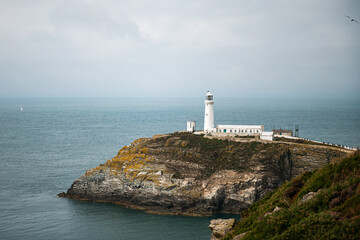 Fototapeta na wymiar South Stack Lighthouse, Wales, Anglesey, UK. It is built on the summit of a small island off the north-west coast of Holy Island. It was built in 1809 to warn ships of the dangerous rocks below.