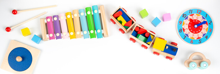 Colorful wooden educational and musical toys for baby kids on white background. Top view, flat lay...