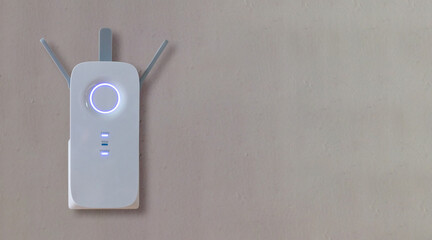 Wireless repeater, Wifi Extender on grey empty wall background. Network booster close up, copy space - obrazy, fototapety, plakaty
