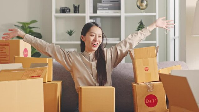 Asian young woman happy with many parcel boxes at home, online shopping addiction concept