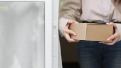 Closeup hands courier delivery man sending box parcel to customer, delivery concept