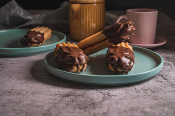 Dark chocolate coated tasty half digestive biscuit with a cup of tea for loved ones valentines day celebration. Partially eaten