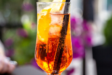 Aperol spritz with orange slice at outside cafe Aperol is an Italian aperitif made of herbs and soda