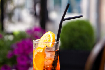 Aperol spritz with orange slice at outside cafe Aperol is an Italian aperitif made of herbs and soda