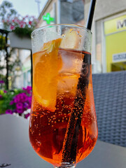 Aperol spritz with orange slice at outside cafe Aperol is an Italian aperitif made of herbs and soda