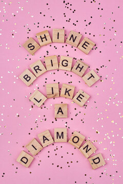 Text shine bright like a diamond written on wooden blocks. Top view and flat lay.