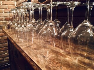 Close-up of wine glasses on a wooden shelf