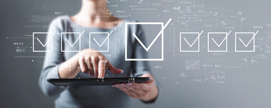 Checklist concept with business woman using a tablet computer